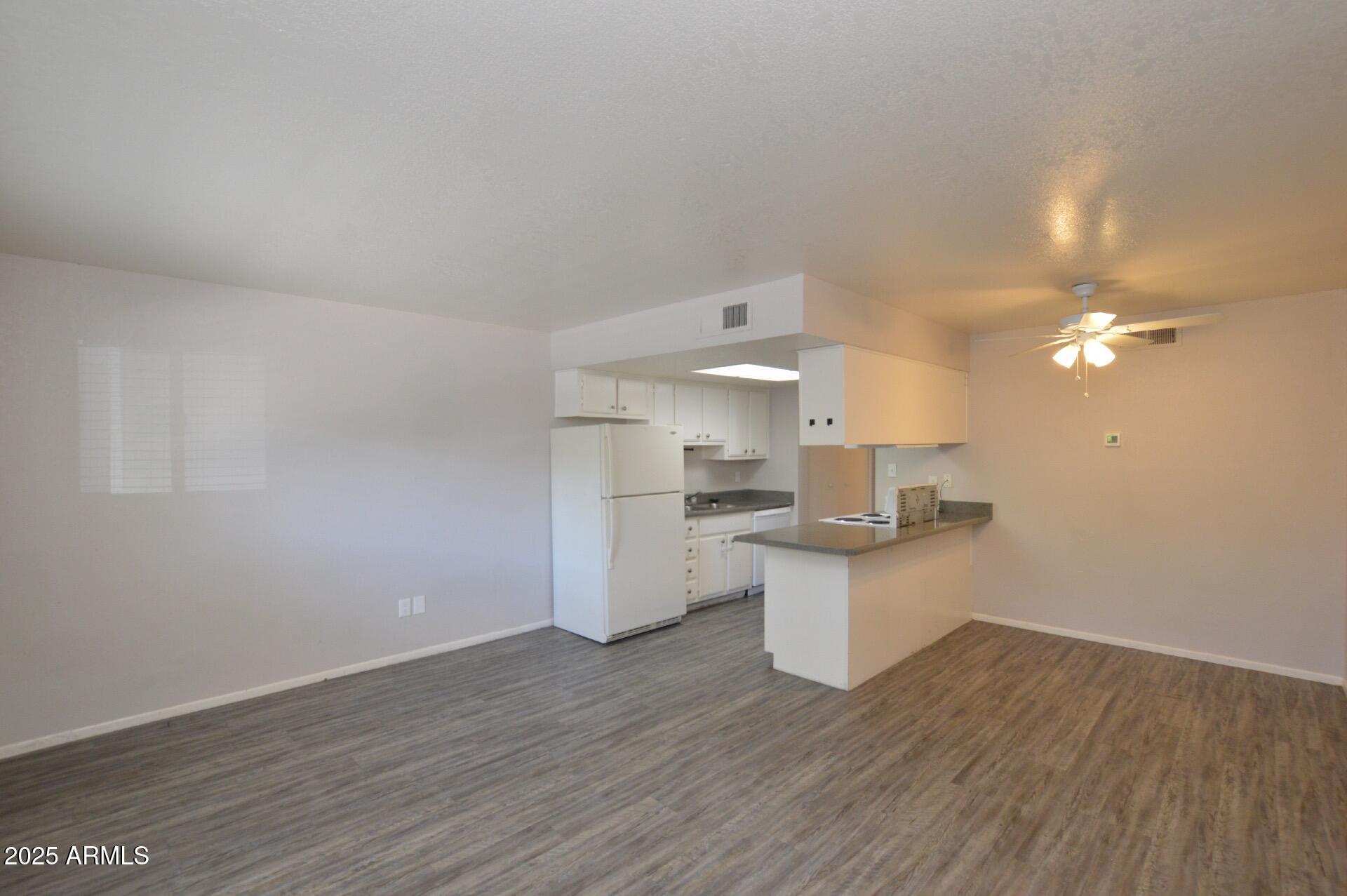 3004 East Waltann Lane, Unit 7 Phoenix, AZ 85032 - Photo 8 of 12 a kitchen with a sink cabinets and wooden floor