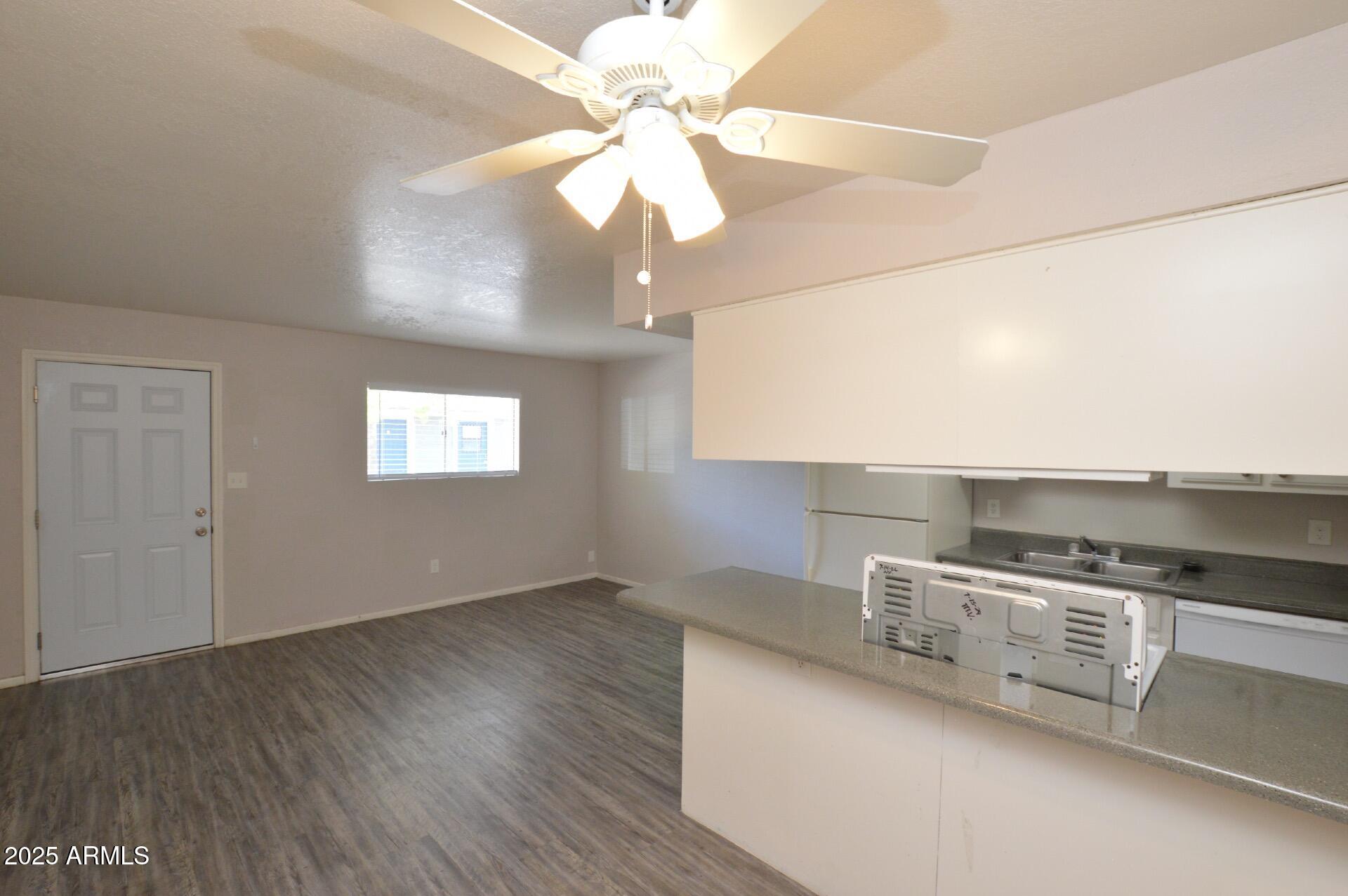 3004 East Waltann Lane, Unit 7 Phoenix, AZ 85032 - Photo 9 of 12 a kitchen with stainless steel appliances granite countertop a sink a stove and a wooden floors