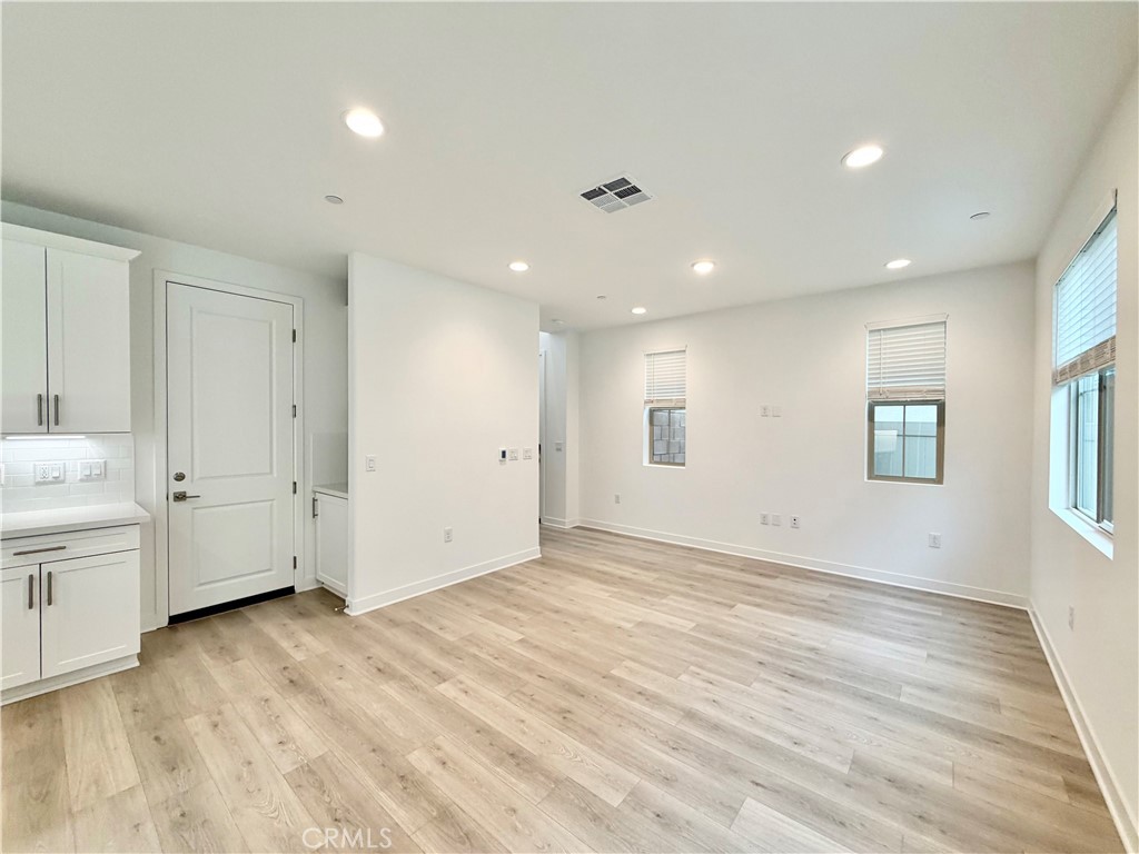 26893 Rubicon Road Menifee, CA 92586 - Photo 7 of 32 a view of empty room with wooden floor and window