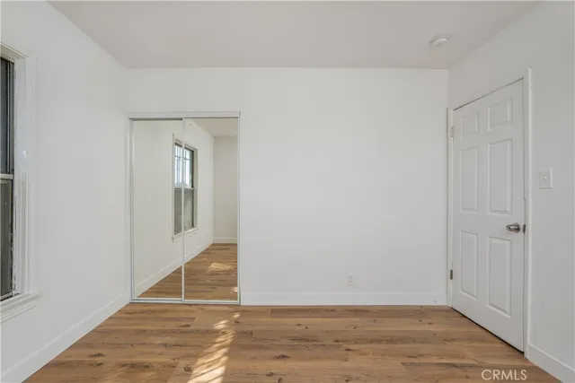 a view of an entryway with wooden floor
