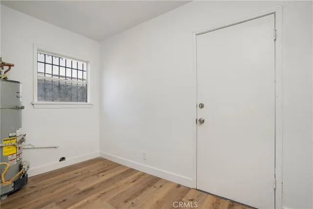 a room view with wooden floor and windows