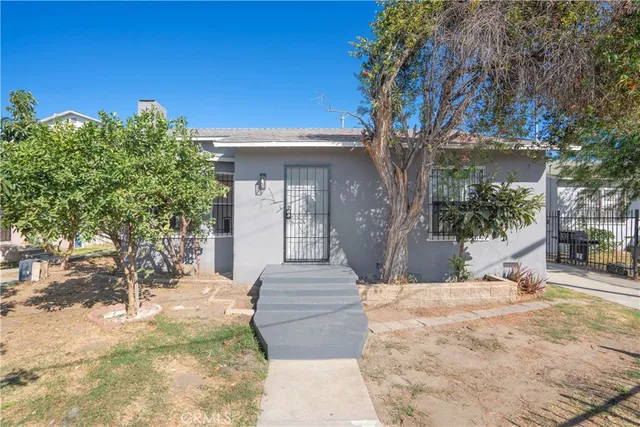 a view of a white house with a yard