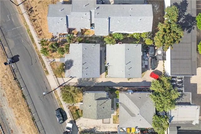 an aerial view of a house with table and chairs and potted plants