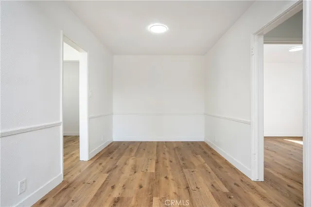 a view of a room with wooden floor