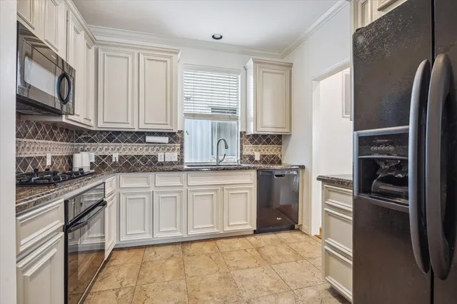 a kitchen with stainless steel appliances granite countertop a refrigerator sink and stove