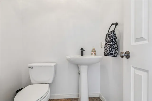a bathroom with a toilet sink and mirror