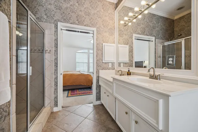 a en suite bathroom with a double vanity sink and a mirror