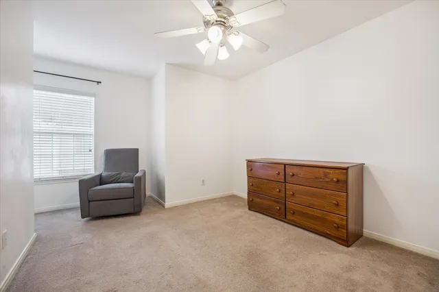 a room with a dresser and a window