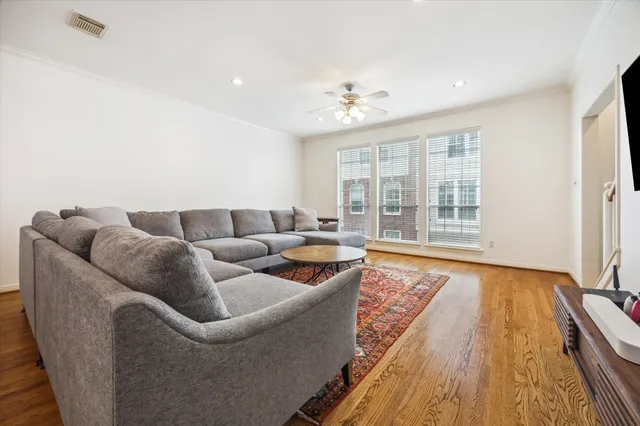 a living room with furniture and wooden floor