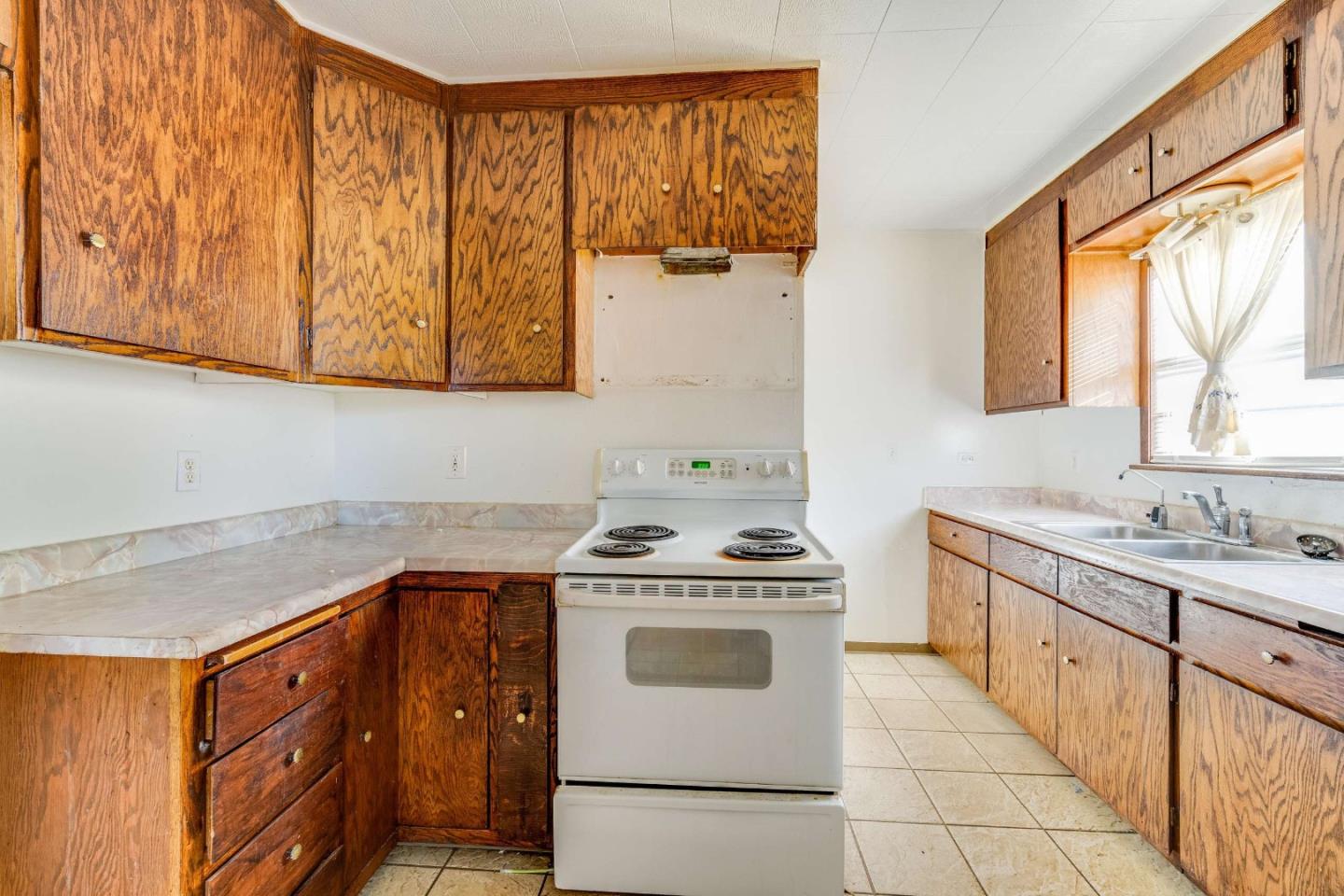 1 Spruce Street Vallejo, CA 94591 - Photo 11 of 35 a kitchen with a stove sink and cabinets