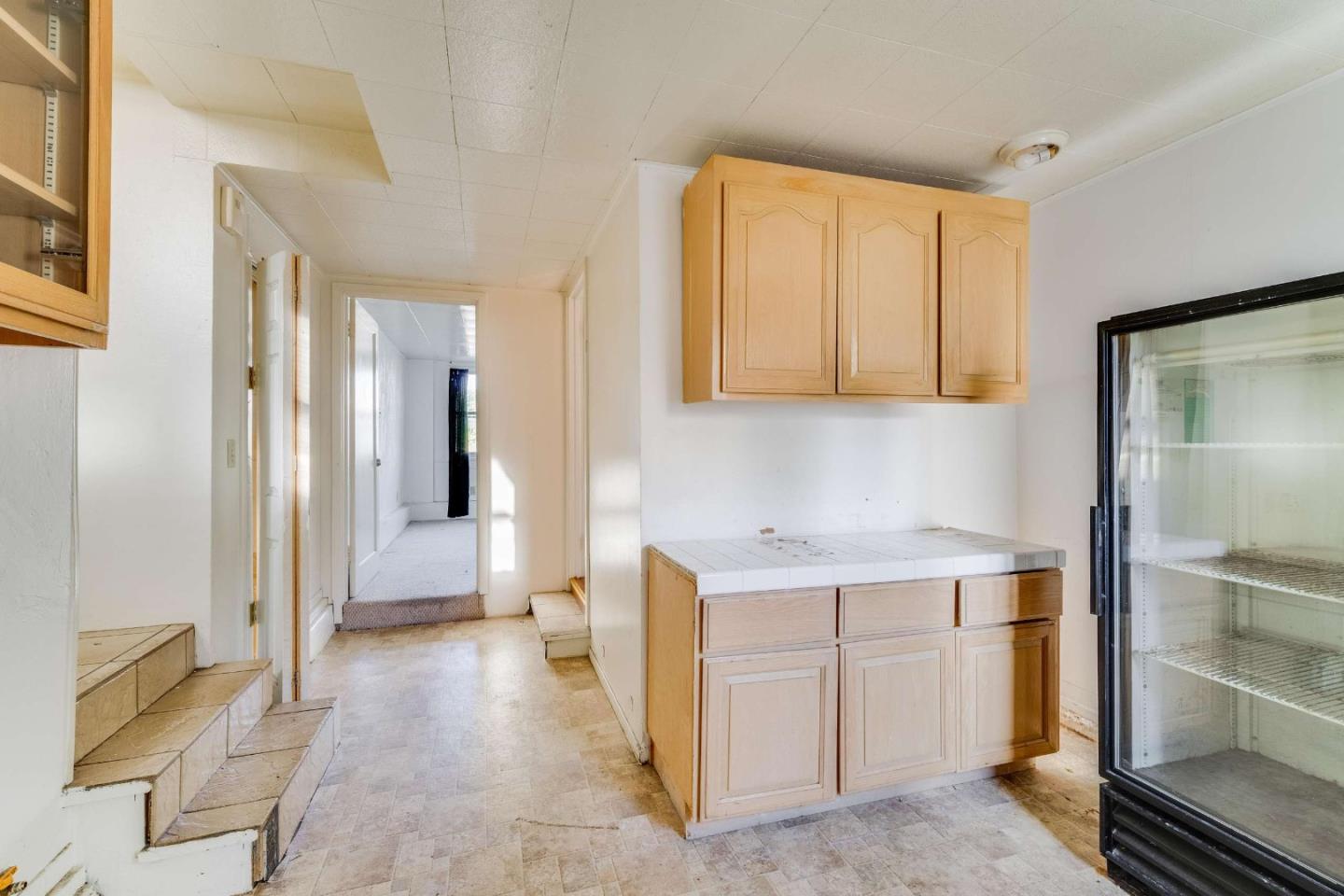 1 Spruce Street Vallejo, CA 94591 - Photo 16 of 35 a view of a kitchen with a fridge and wooden floor