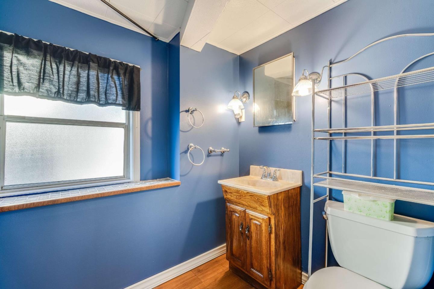 1 Spruce Street Vallejo, CA 94591 - Photo 18 of 35 a bathroom with a sink a toilet and a mirror