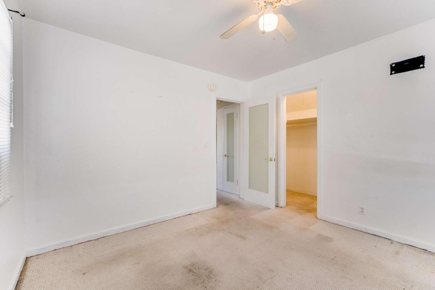 1 Spruce Street Vallejo, CA 94591 - Photo 26 of 35 an empty room with a ceiling fan and a window