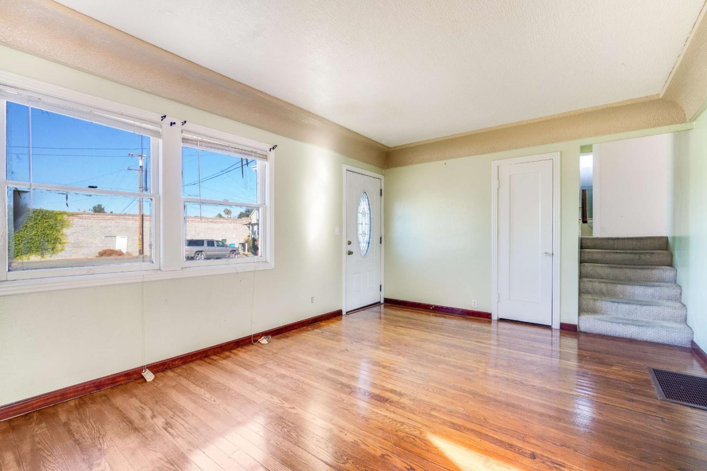1 Spruce Street Vallejo, CA 94591 - Photo 6 of 35 a view of an empty room with wooden floor and a window