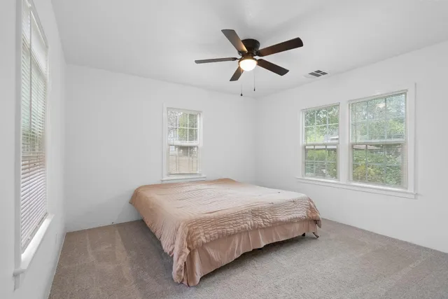 a bedroom with a bed and window