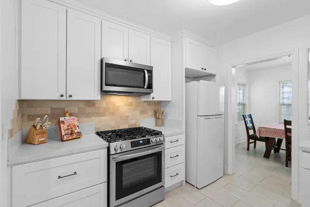a kitchen with cabinets stainless steel appliances and a counter space