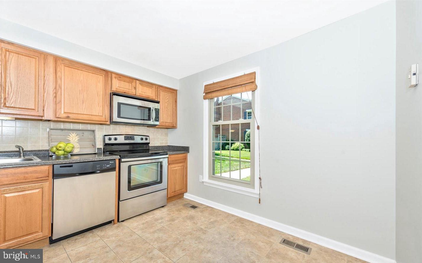 8220 Red Wing Court Frederick, MD 21701 - Photo 2 of 17 a kitchen with a sink a stove and cabinets
