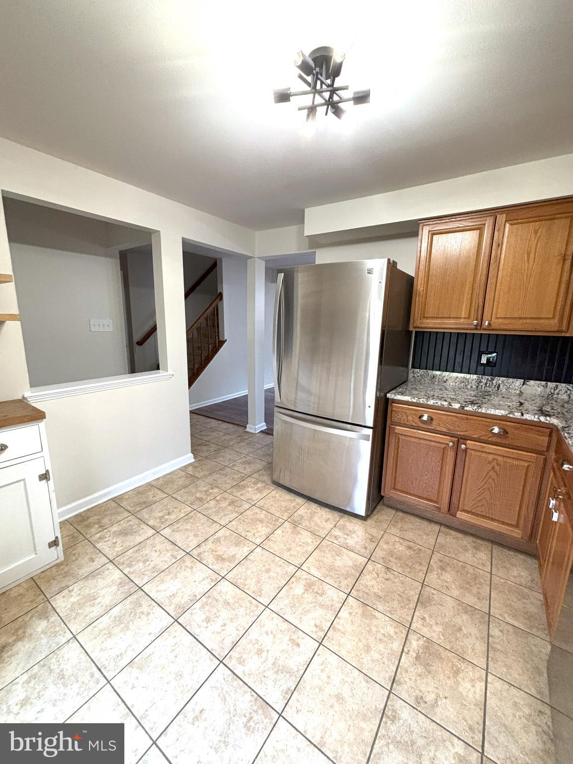 8220 Red Wing Court Frederick, MD 21701 - Photo 4 of 17 a kitchen with kitchen island a stove a sink and a refrigerator