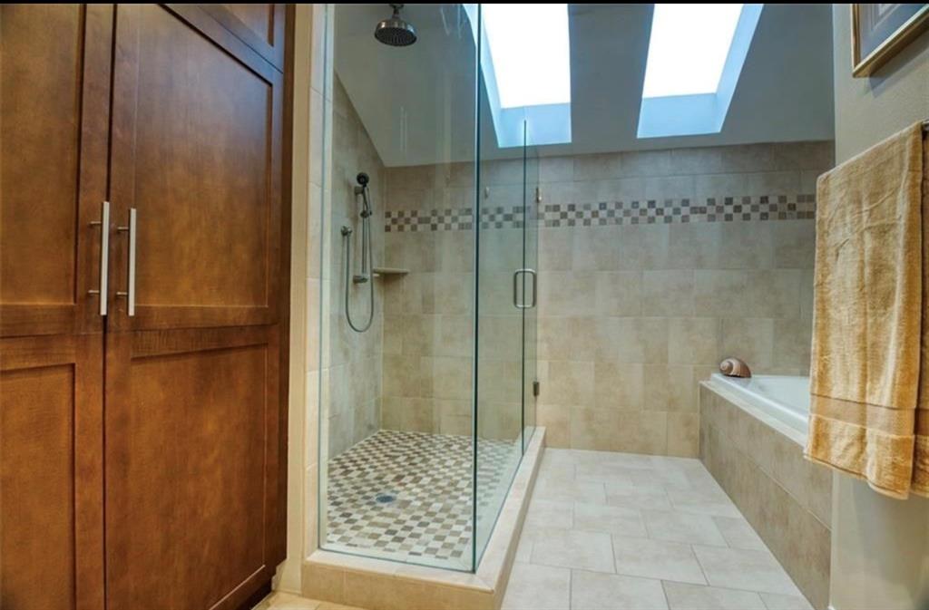 4970 Thunder Road Dallas, TX 75244 - Photo 10 of 19 Phenomenal modern primary bath has a beautiful walk-in closet and extraordinary looking- glass walled adjacent to bathtub. .Total luxurious feel
