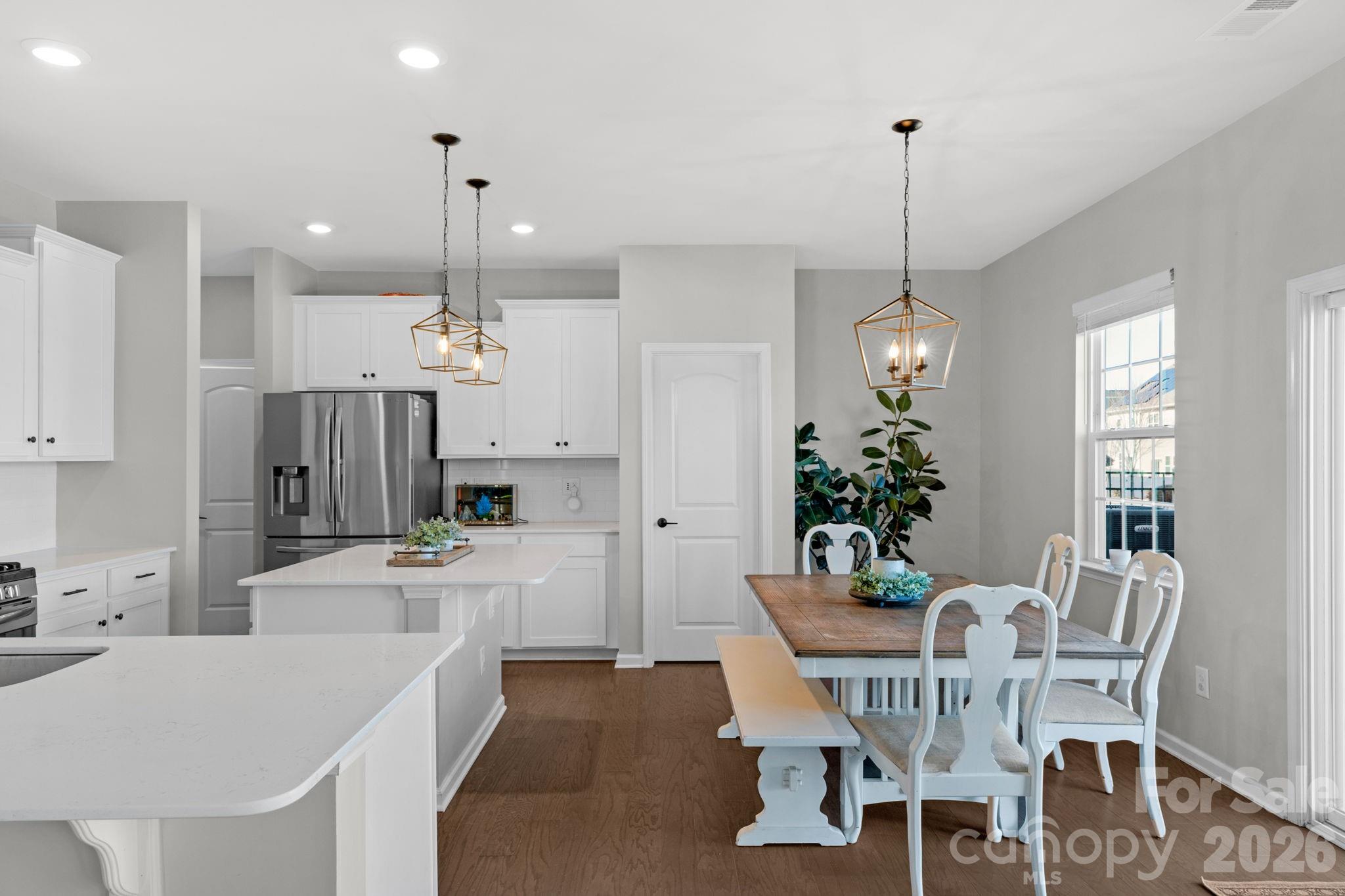 4280 Coachwhip Avenue Lancaster, SC 29720 - Photo 16 of 48 a view of a dining room and a kitchen with a table chairs