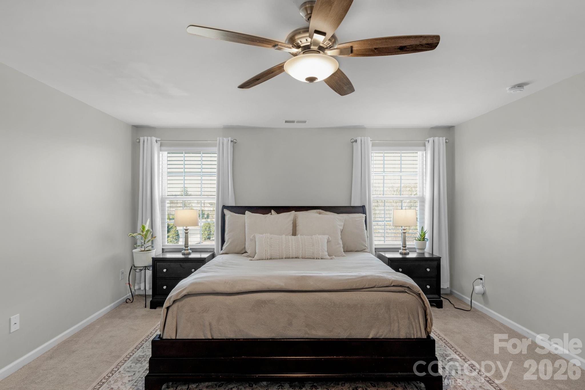 4280 Coachwhip Avenue Lancaster, SC 29720 - Photo 30 of 48 a bedroom with a large bed and a ceiling fan