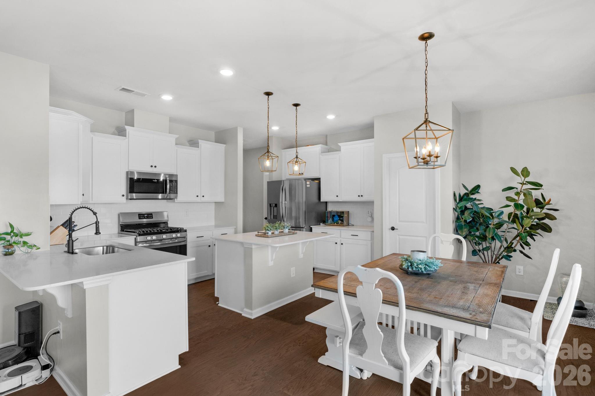 4280 Coachwhip Avenue Lancaster, SC 29720 - Photo 3 of 48 a kitchen with stainless steel appliances kitchen island granite countertop a sink and cabinets