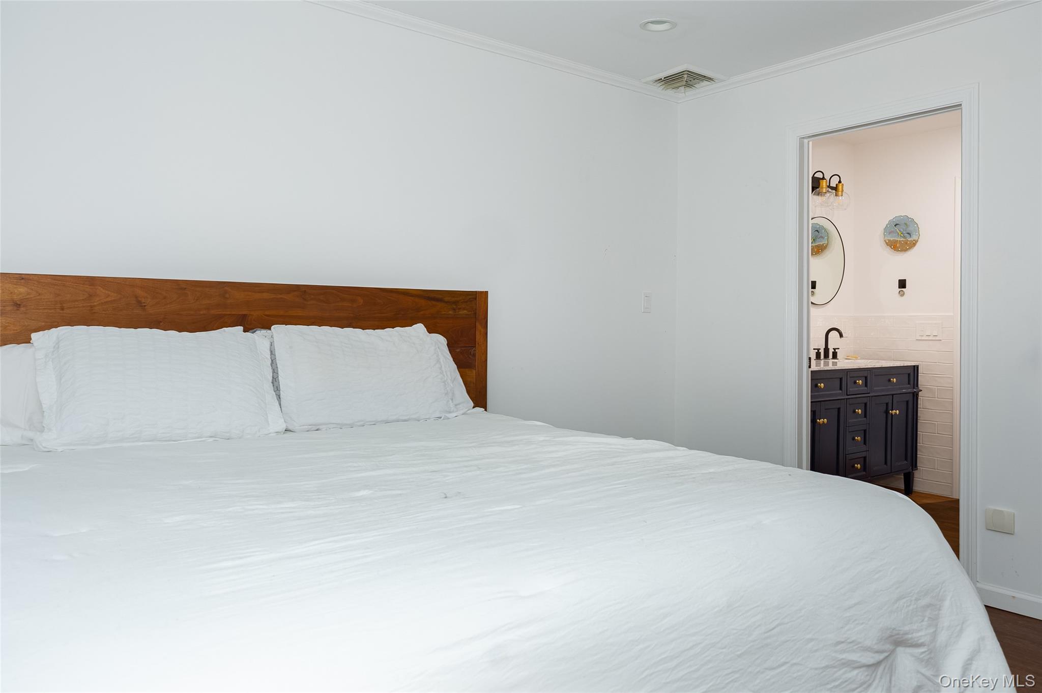 921 West Dover Road Pawling, NY 12564 - Photo 13 of 36 Spacious bedroom with white walls and a warm wood-finish headboard