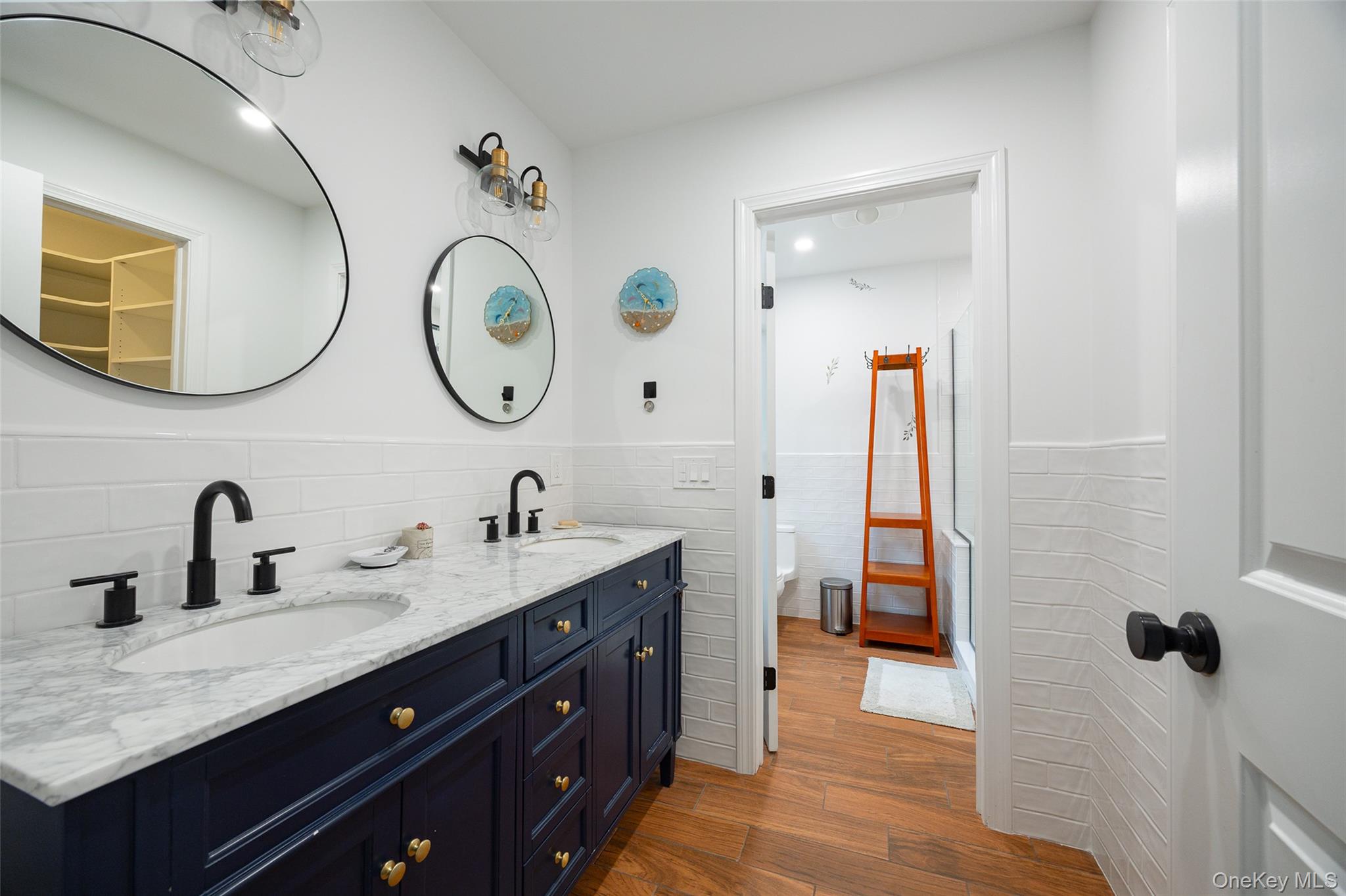 921 West Dover Road Pawling, NY 12564 - Photo 14 of 36 Double vanity featuring a white marble-patterned countertop, dual undermount sinks, and matte black fixtures