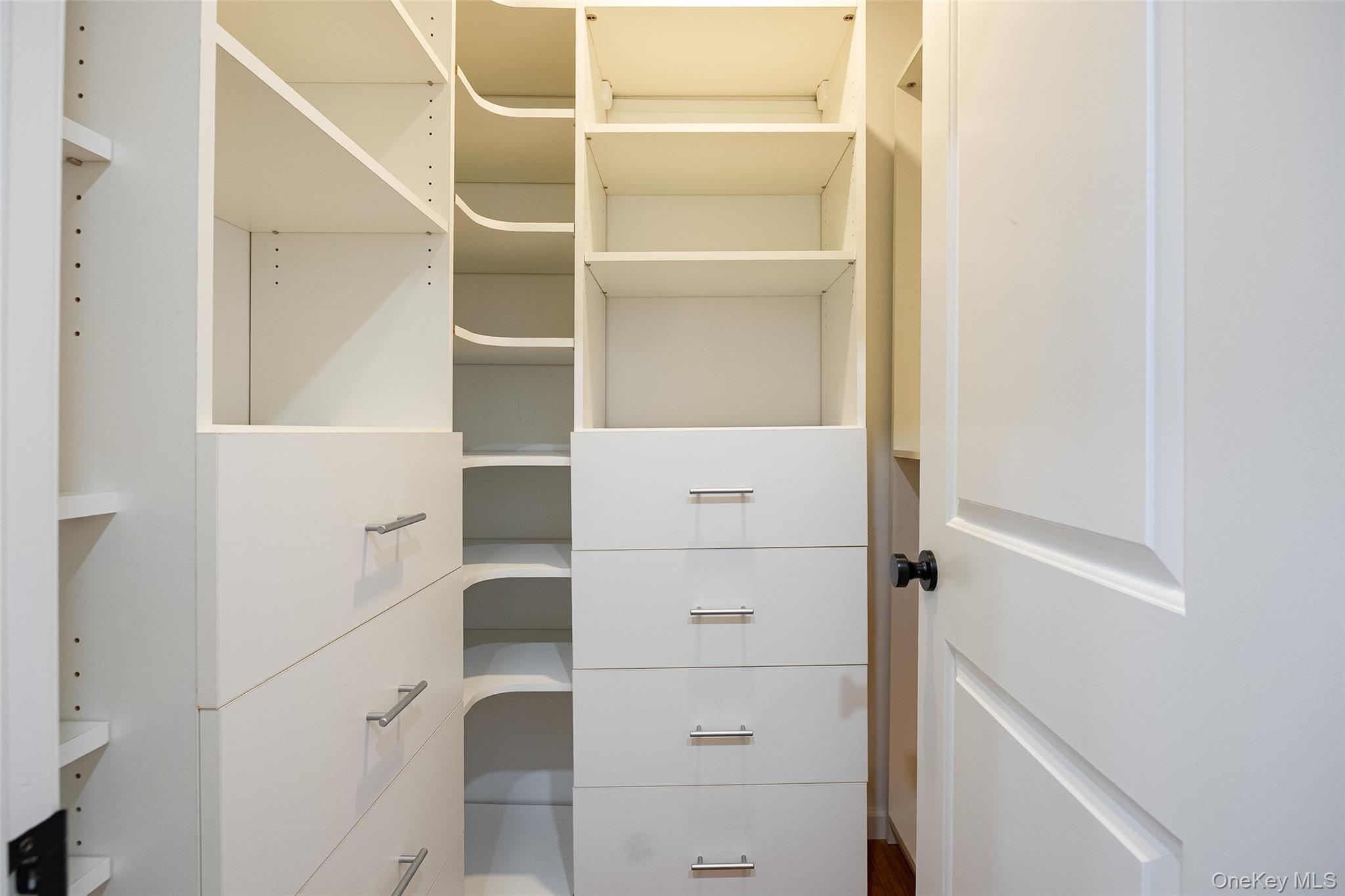 921 West Dover Road Pawling, NY 12564 - Photo 15 of 36 Custom closet system featuring multiple shelving units, built-in drawers with modern pulls, and integrated corner shelving