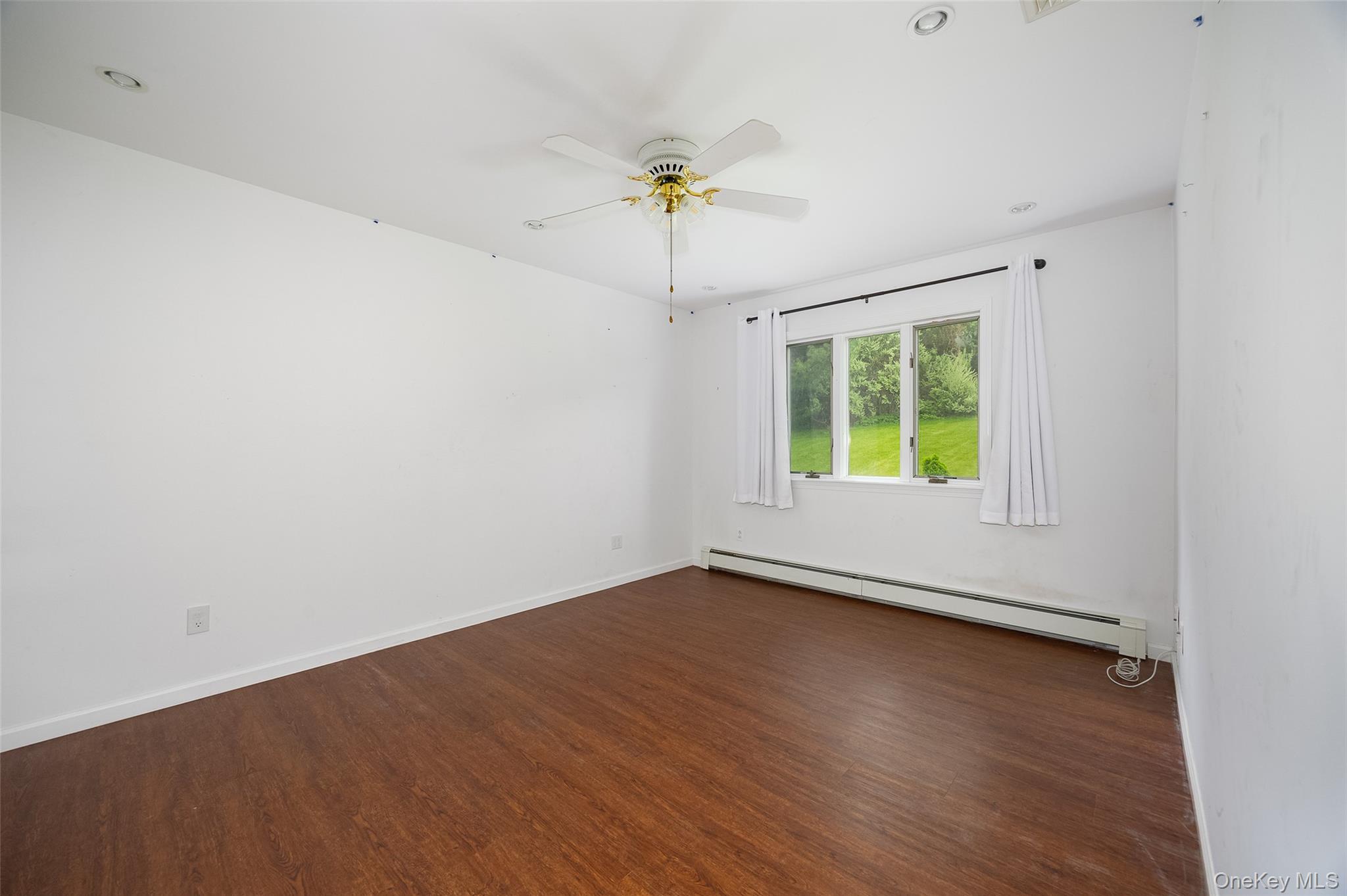 921 West Dover Road Pawling, NY 12564 - Photo 19 of 36 Room featuring wood-finish flooring, white walls, and a multi-pane window with a green outdoor scenery