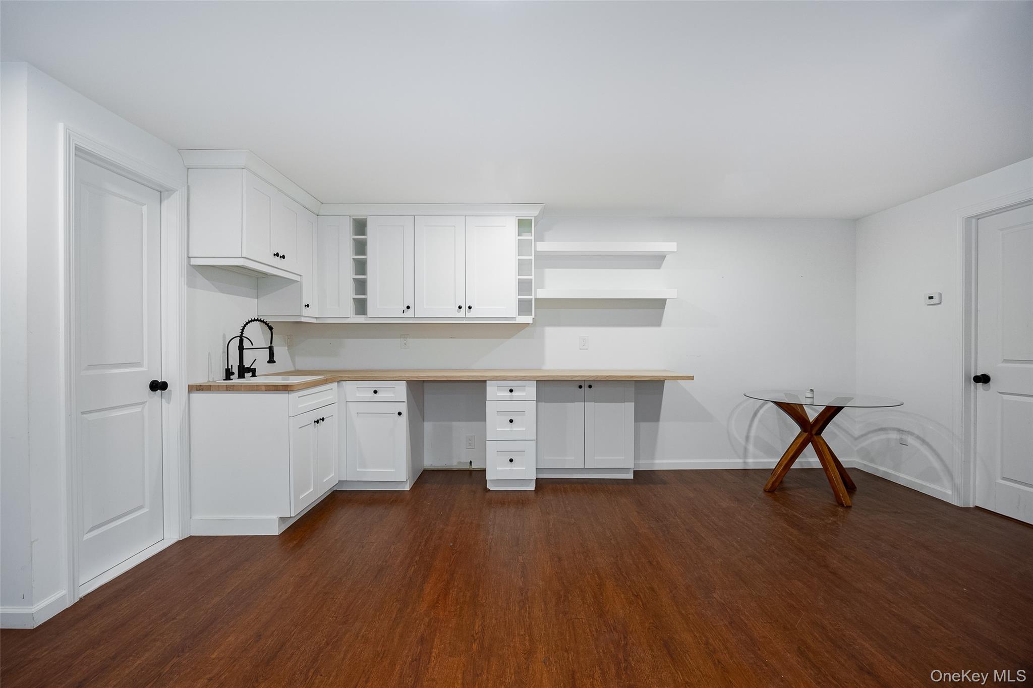 921 West Dover Road Pawling, NY 12564 - Photo 26 of 36 White cabinetry with a wood-finish countertop, undermount sink, and matte black faucet