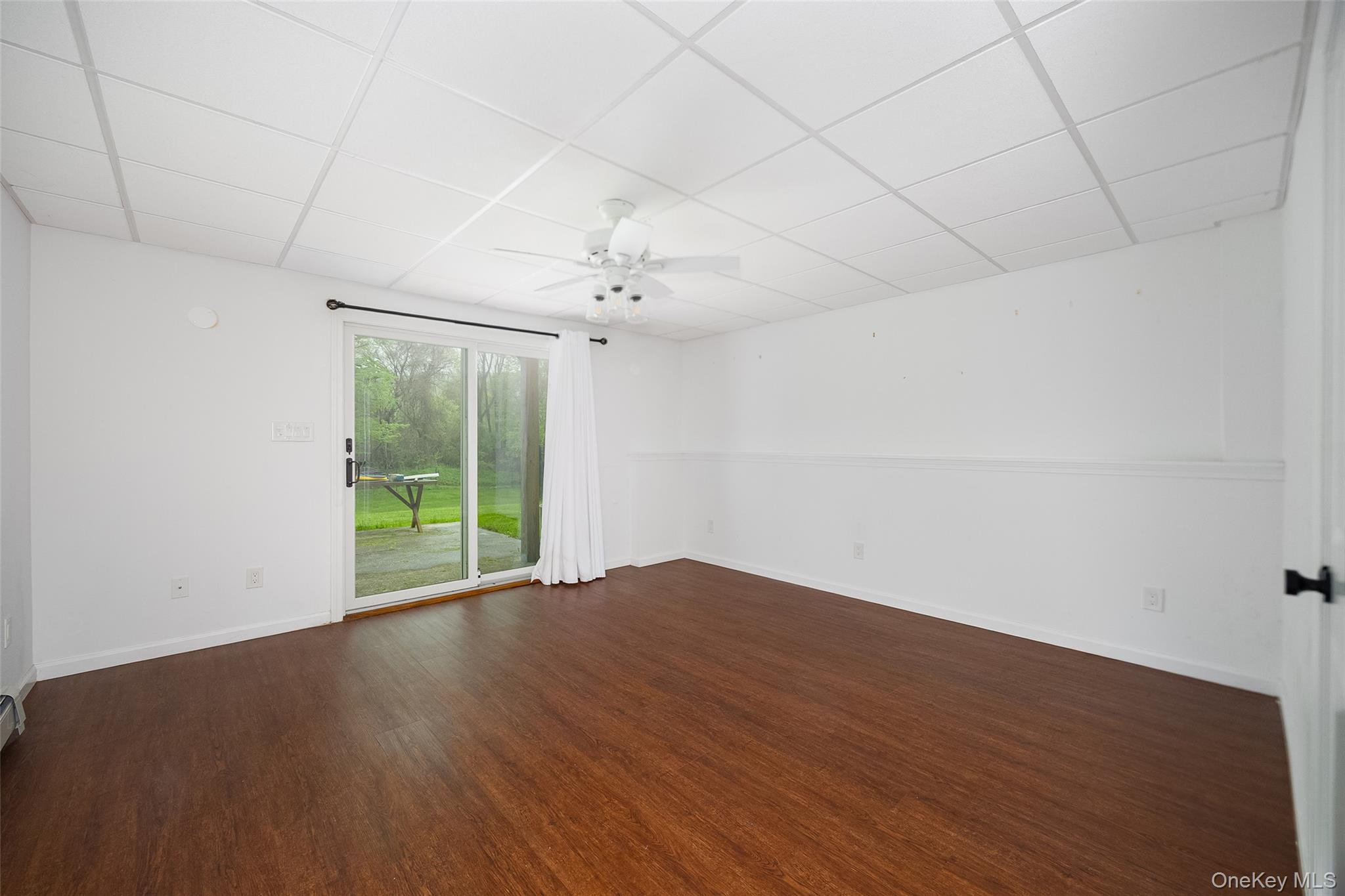 921 West Dover Road Pawling, NY 12564 - Photo 28 of 36 Spacious room with wood-finish flooring, white walls, and a drop ceiling