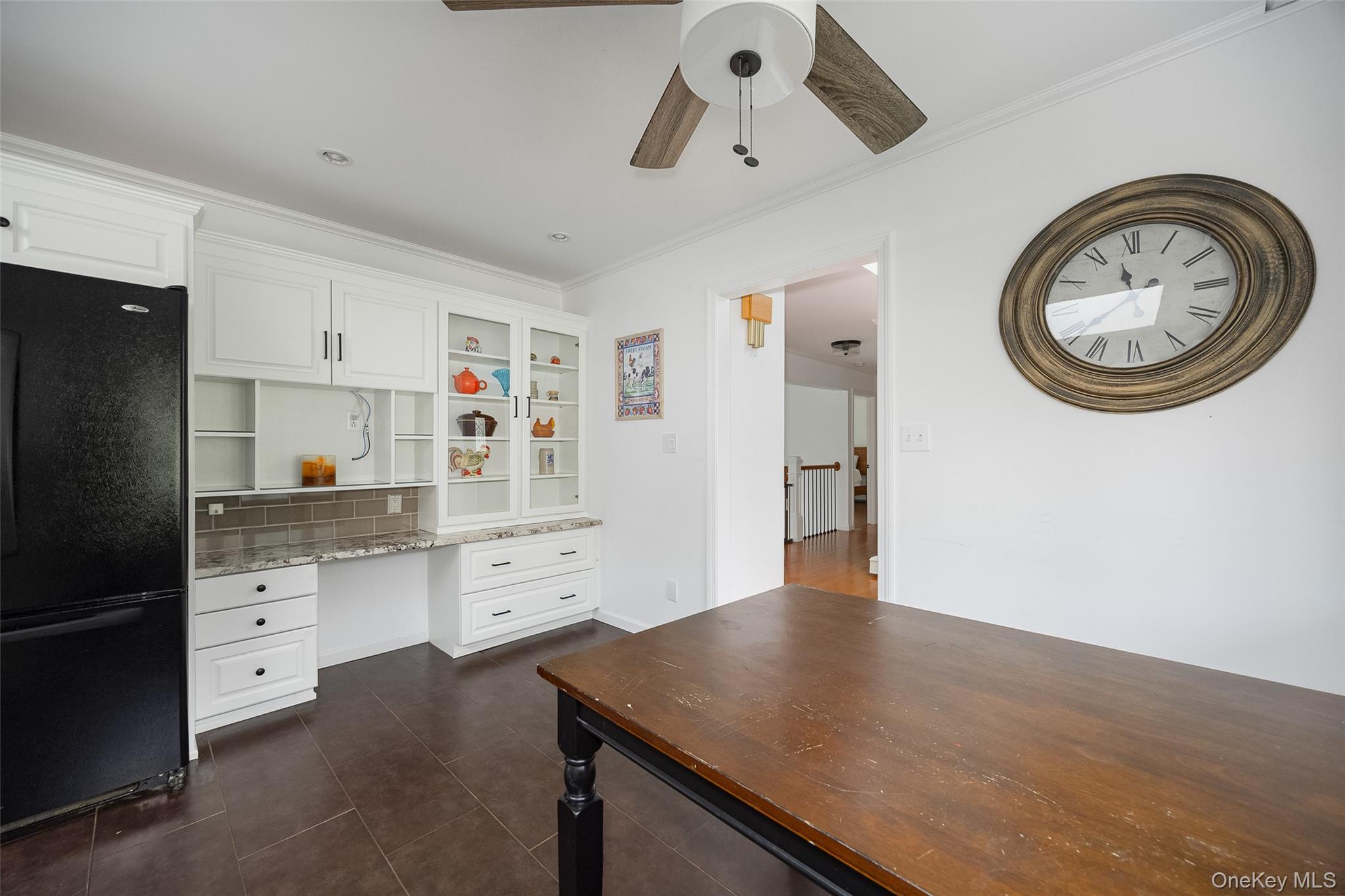921 West Dover Road Pawling, NY 12564 - Photo 7 of 36 Built-in white cabinetry with glass-front display uppers, granite-look countertops, and a tiled backsplash