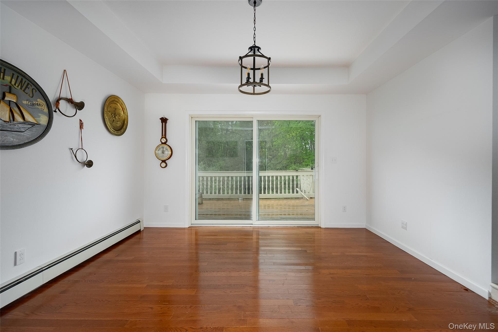 921 West Dover Road Pawling, NY 12564 - Photo 9 of 36 Spacious room featuring wood-finish flooring, a tray ceiling, and a dark metal chandelier