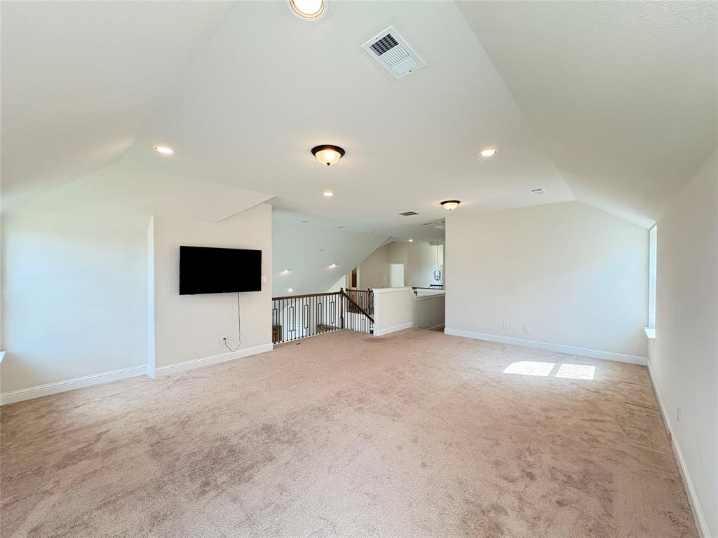 323 Butternut Way Irving, TX 75063 - Photo 22 of 32 a view of a livingroom with a flat screen tv and kitchen view