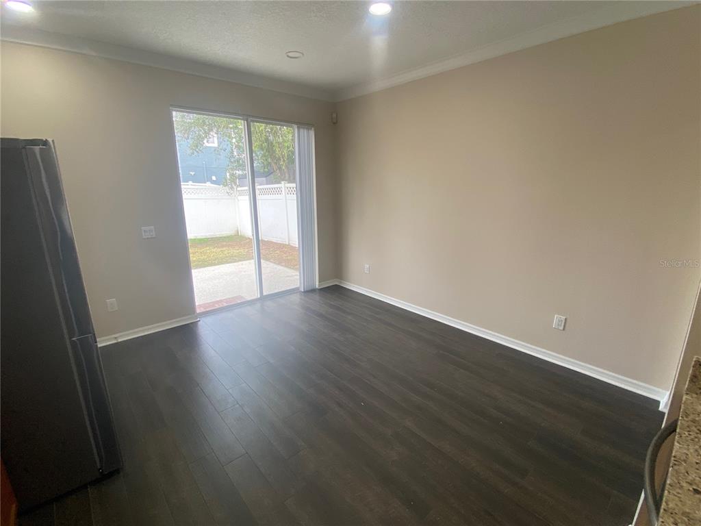 2409 Spring Hollow Loop Wesley Chapel, FL 33544 - Photo 10 of 47 an empty room with wooden floor and windows