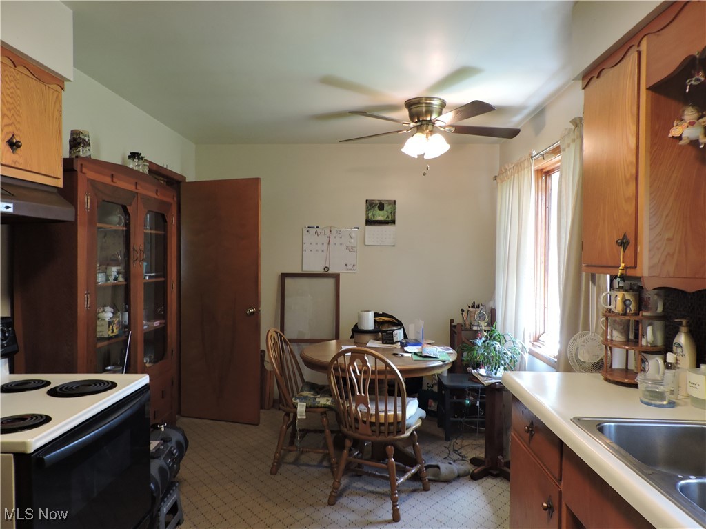 39115 Parsons Road Grafton, OH 44044 - Photo 2 of 9 Kitchen featuring a ceiling fan, a sink, light countertops, electric range, and under cabinet range hood