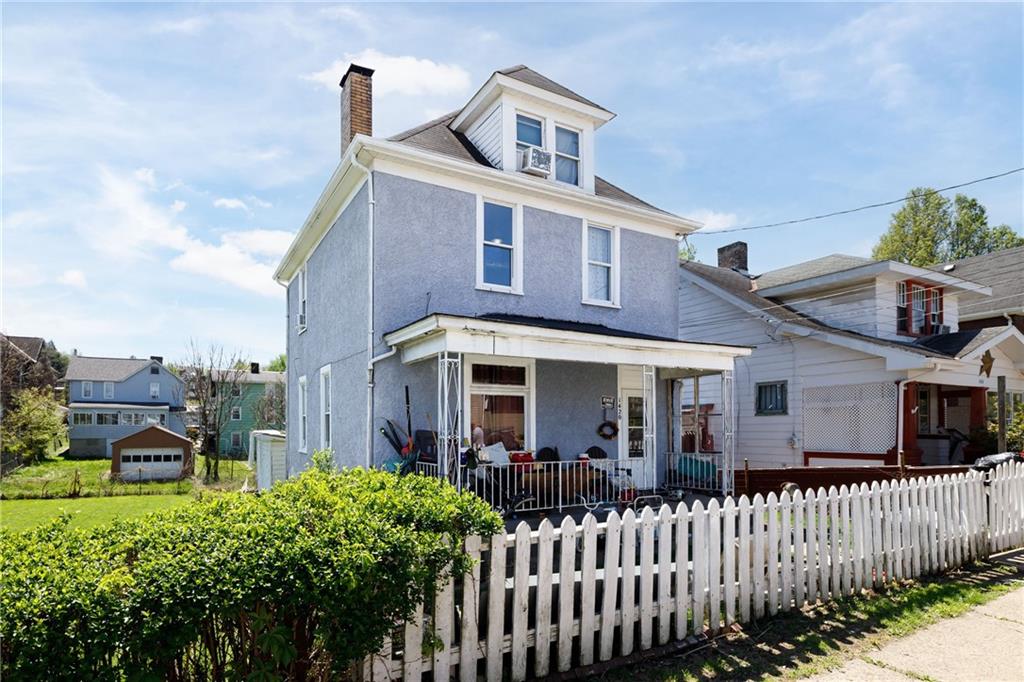 a front view of a house with a garden