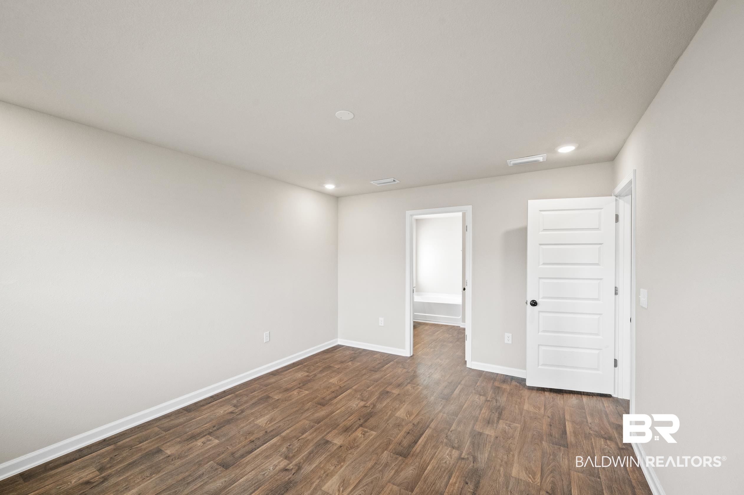 10353 Zenyatta Loop Daphne, AL 36526 - Photo 14 of 33 Unfurnished bedroom with hardwood / wood-style floors