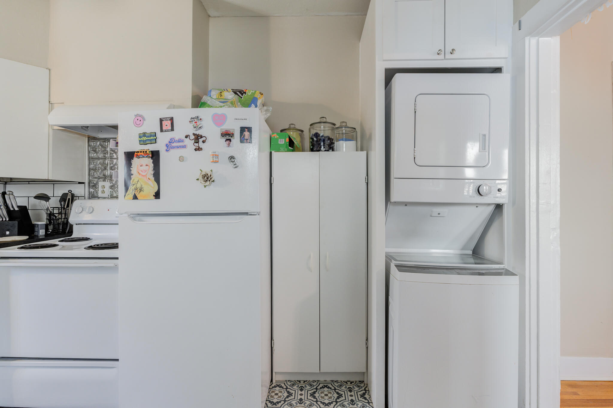 2606 22nd Street Lubbock, TX 79410 - Photo 12 of 24 a white refrigerator freezer and a stove sitting inside of a kitchen