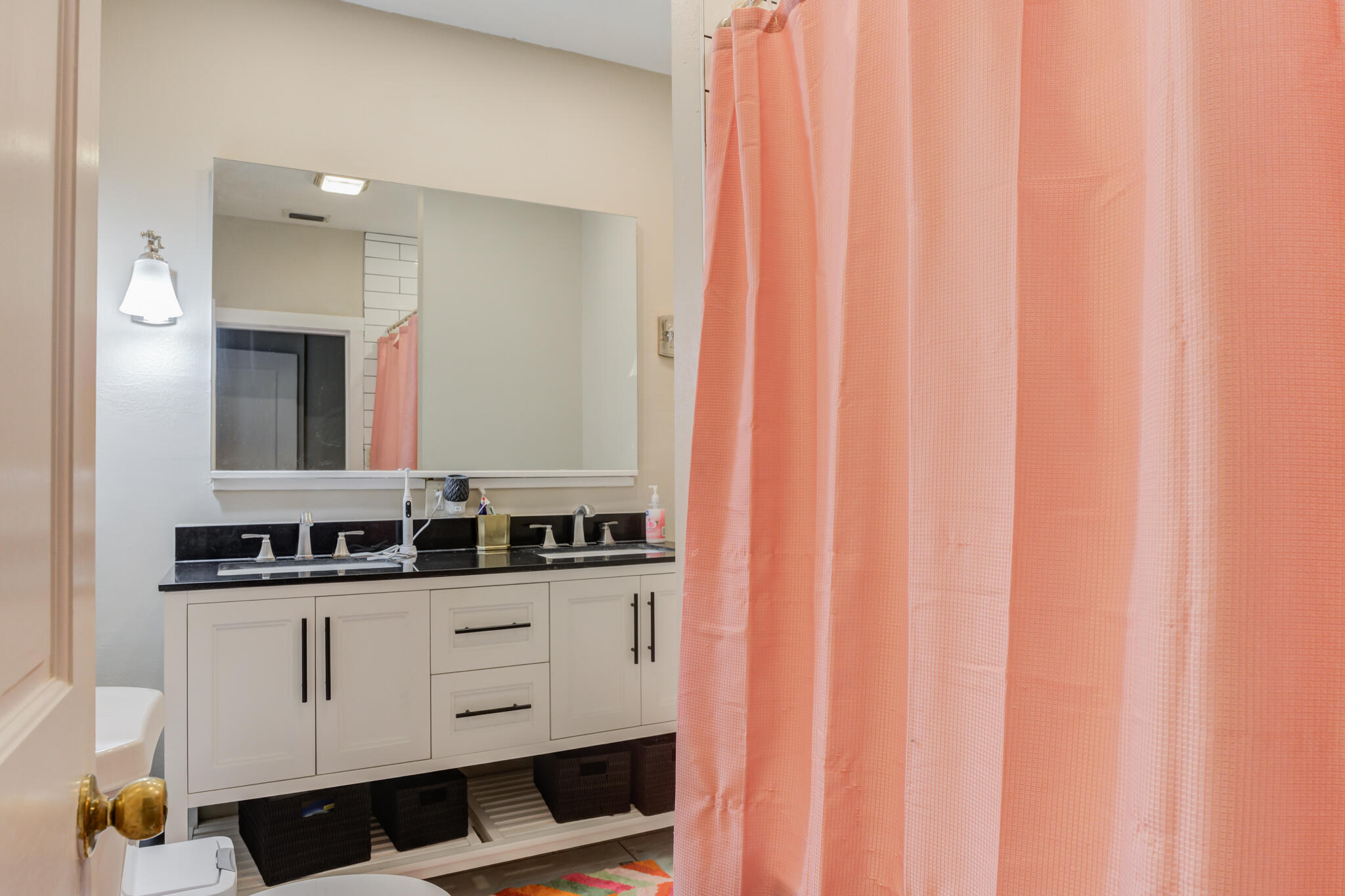 2606 22nd Street Lubbock, TX 79410 - Photo 19 of 24 a bathroom with a double vanity sink and mirror