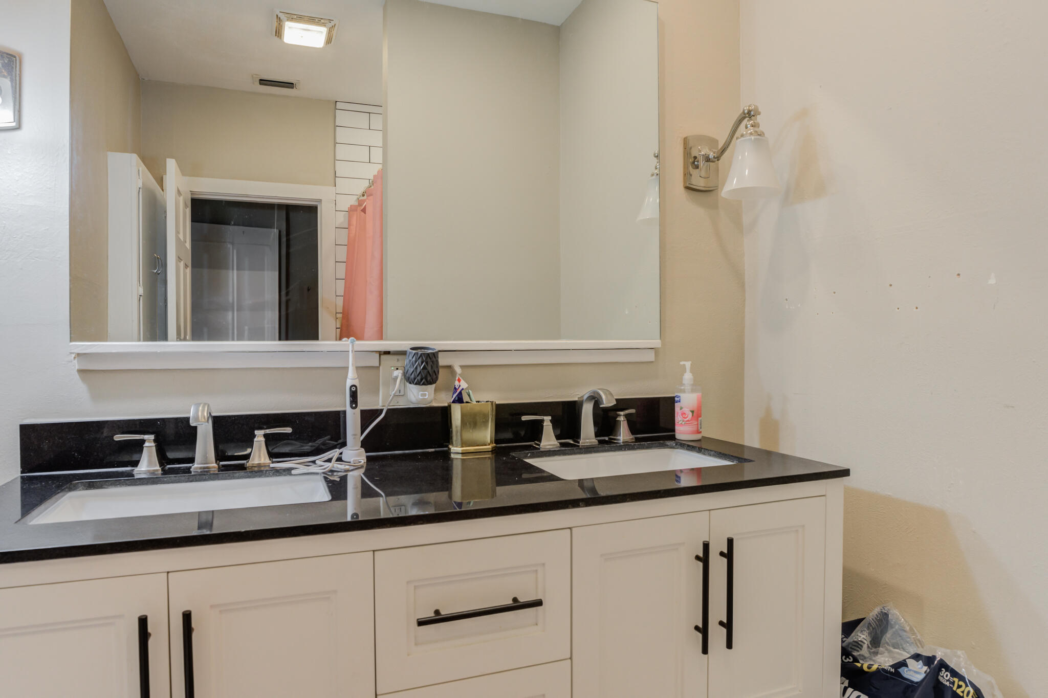 2606 22nd Street Lubbock, TX 79410 - Photo 20 of 24 a bathroom with a sink and a mirror