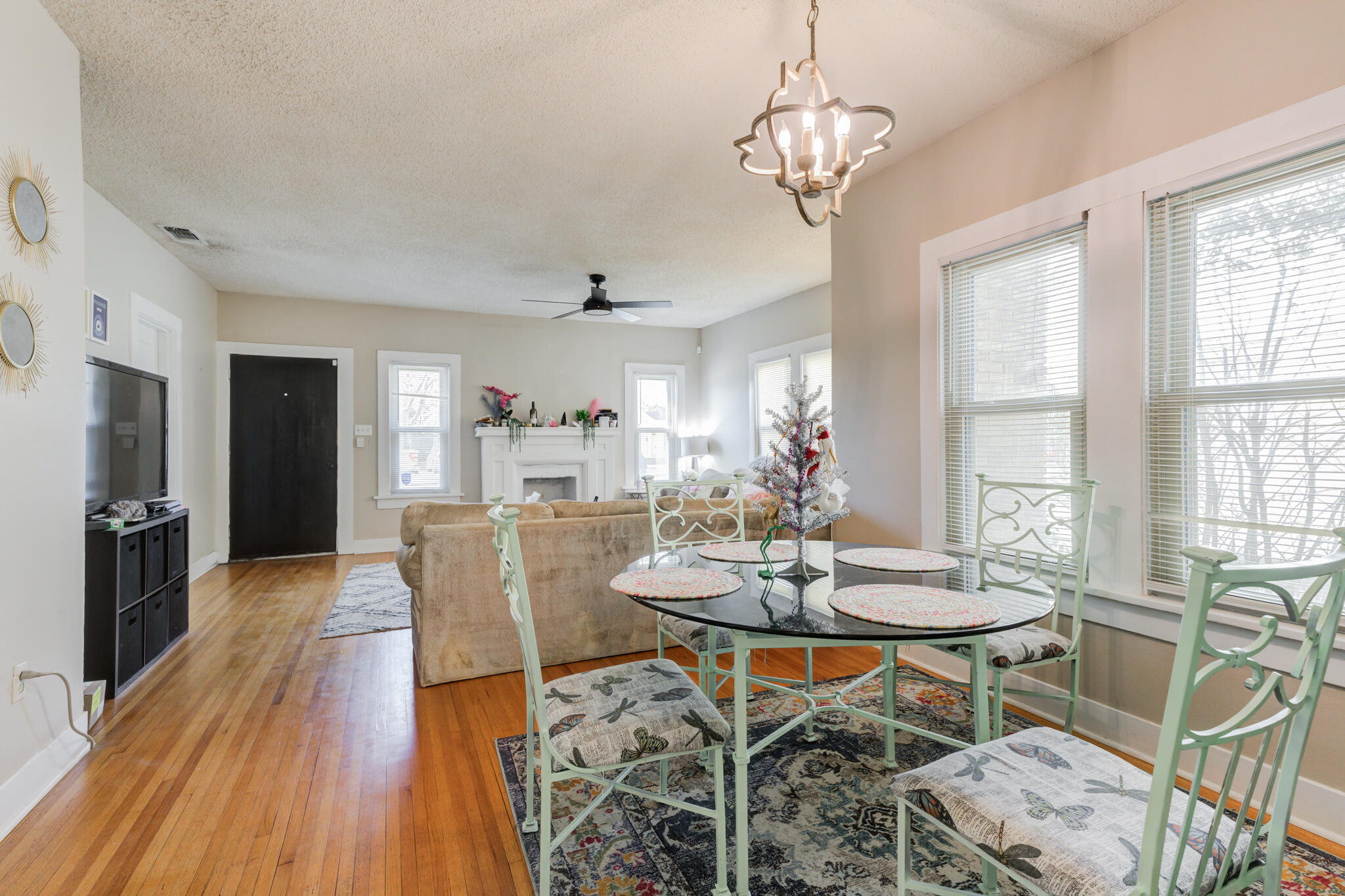 2606 22nd Street Lubbock, TX 79410 - Photo 8 of 24 a dining room with furniture a chandelier and wooden floor