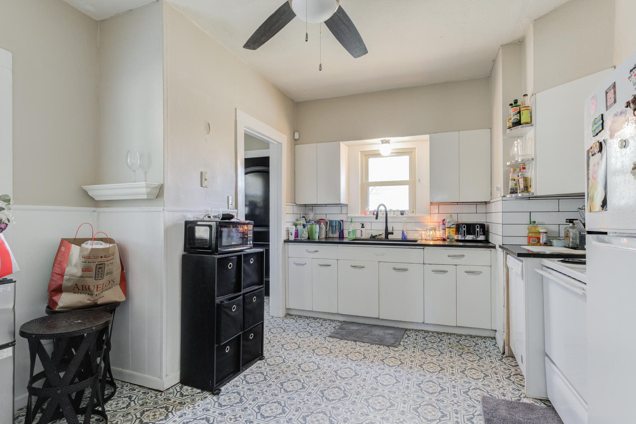 2606 22nd Street Lubbock, TX 79410 - Photo 9 of 24 a kitchen with a sink window and cabinets