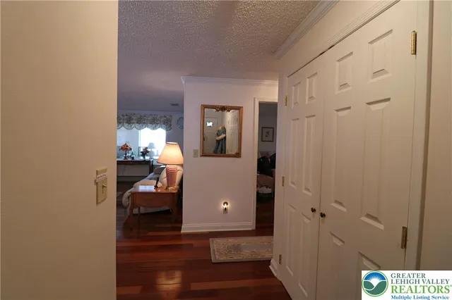 a view of a room with wooden floor and furniture
