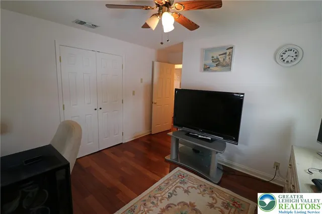 a bedroom with furniture and wooden floor