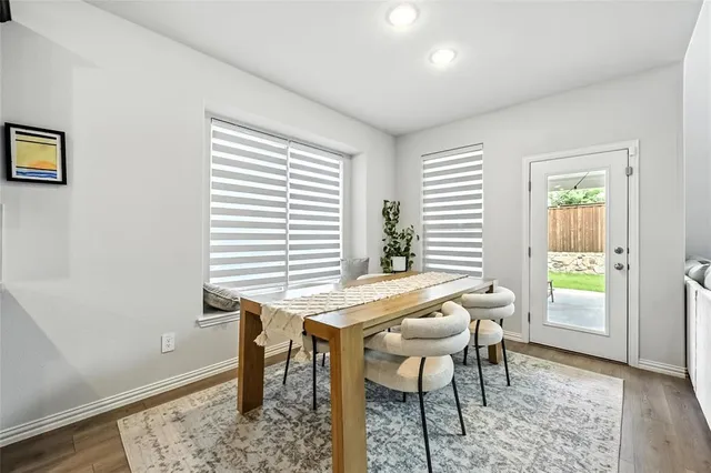 a view of a dining room with furniture and a window