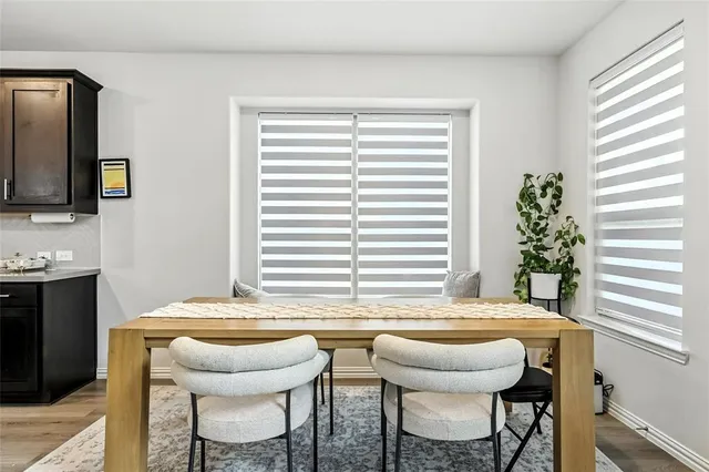 a kitchen with a table chairs and a window
