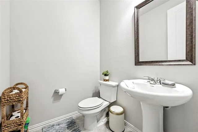 a white toilet sitting next to a bathroom sink
