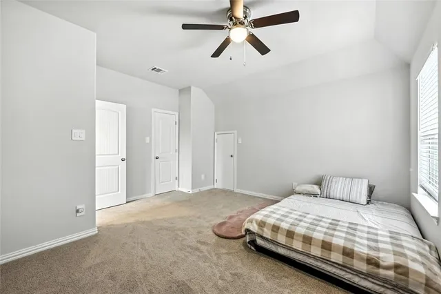 a bedroom with a bed and window